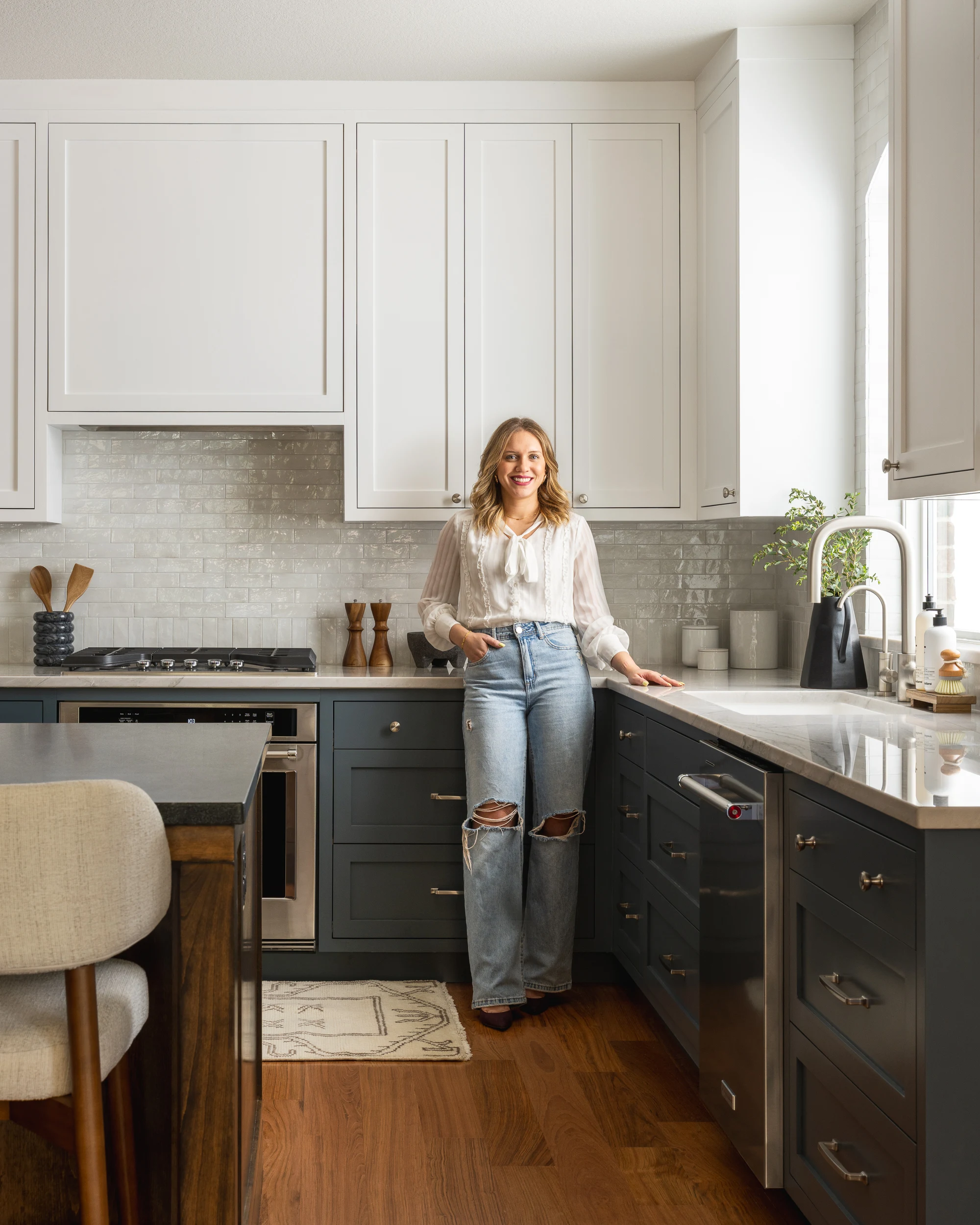 Julia Harrison beside the range, the quartzite counter running past her