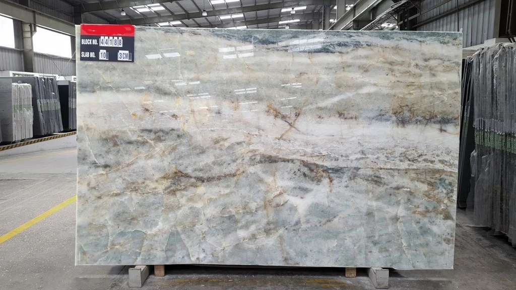 A full Barcelona quartzite slab standing on a stone warehouse floor