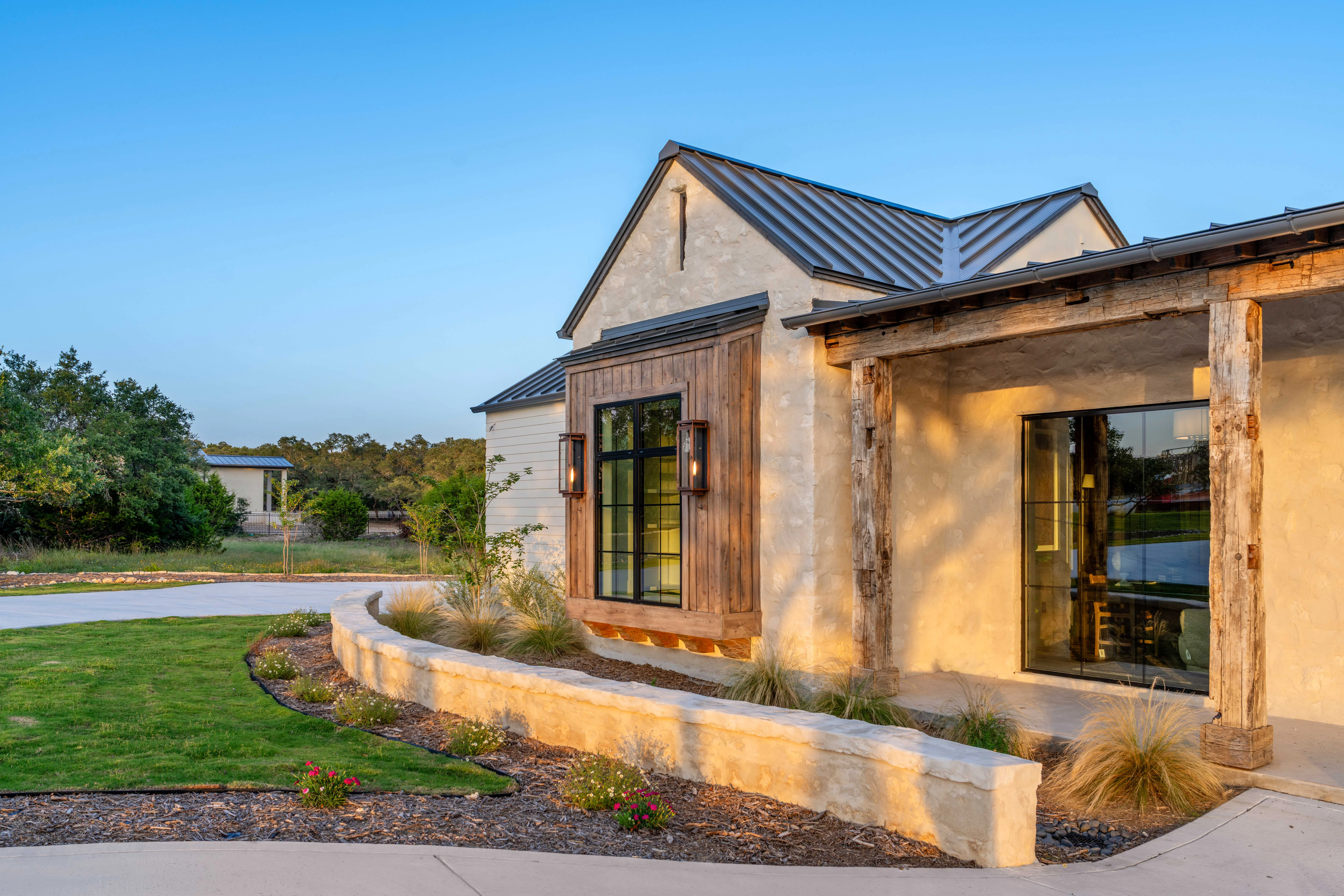 Stone and timber elevation under a standing-seam roof