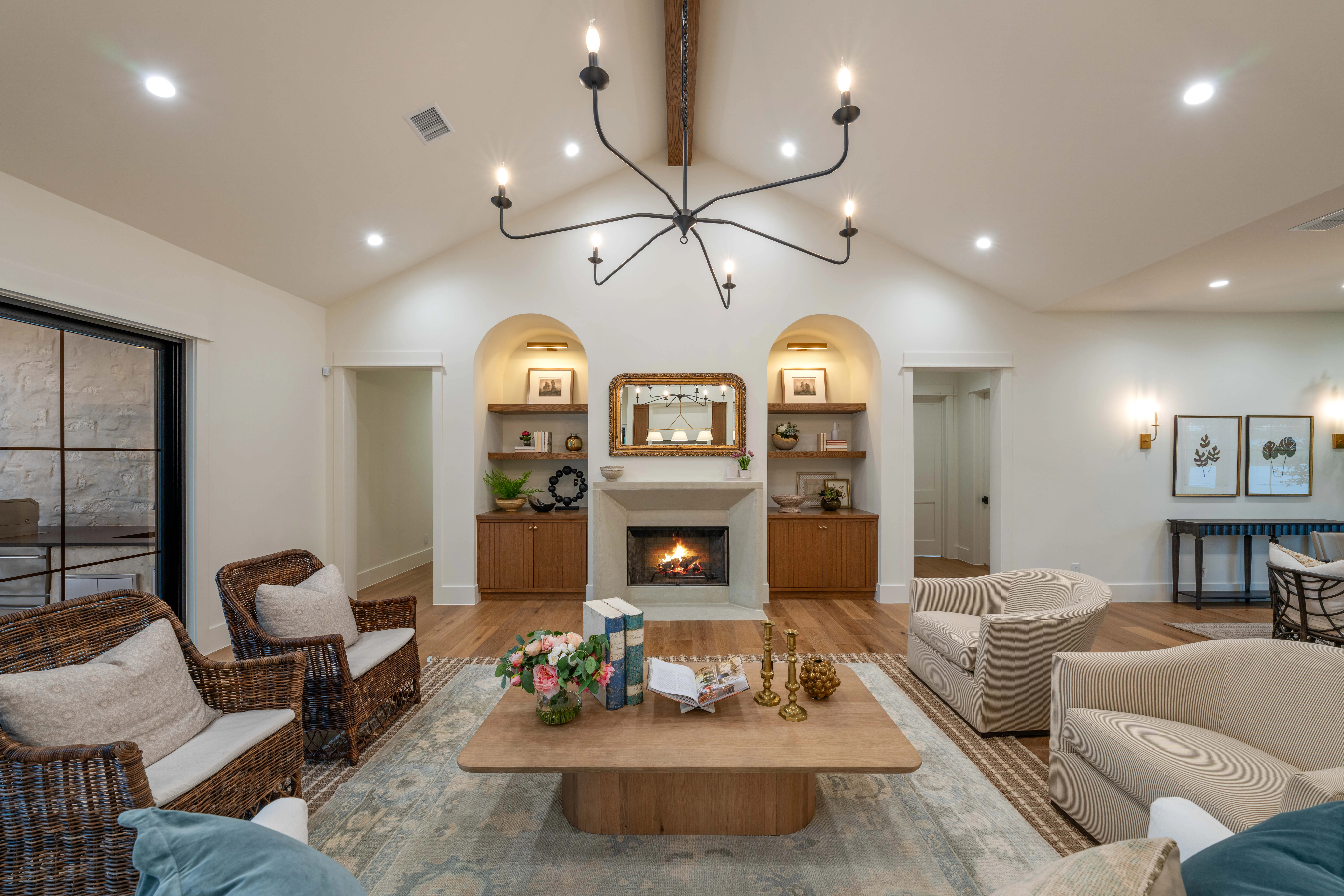 Great room seating grouped around the fireplace and arched built-ins