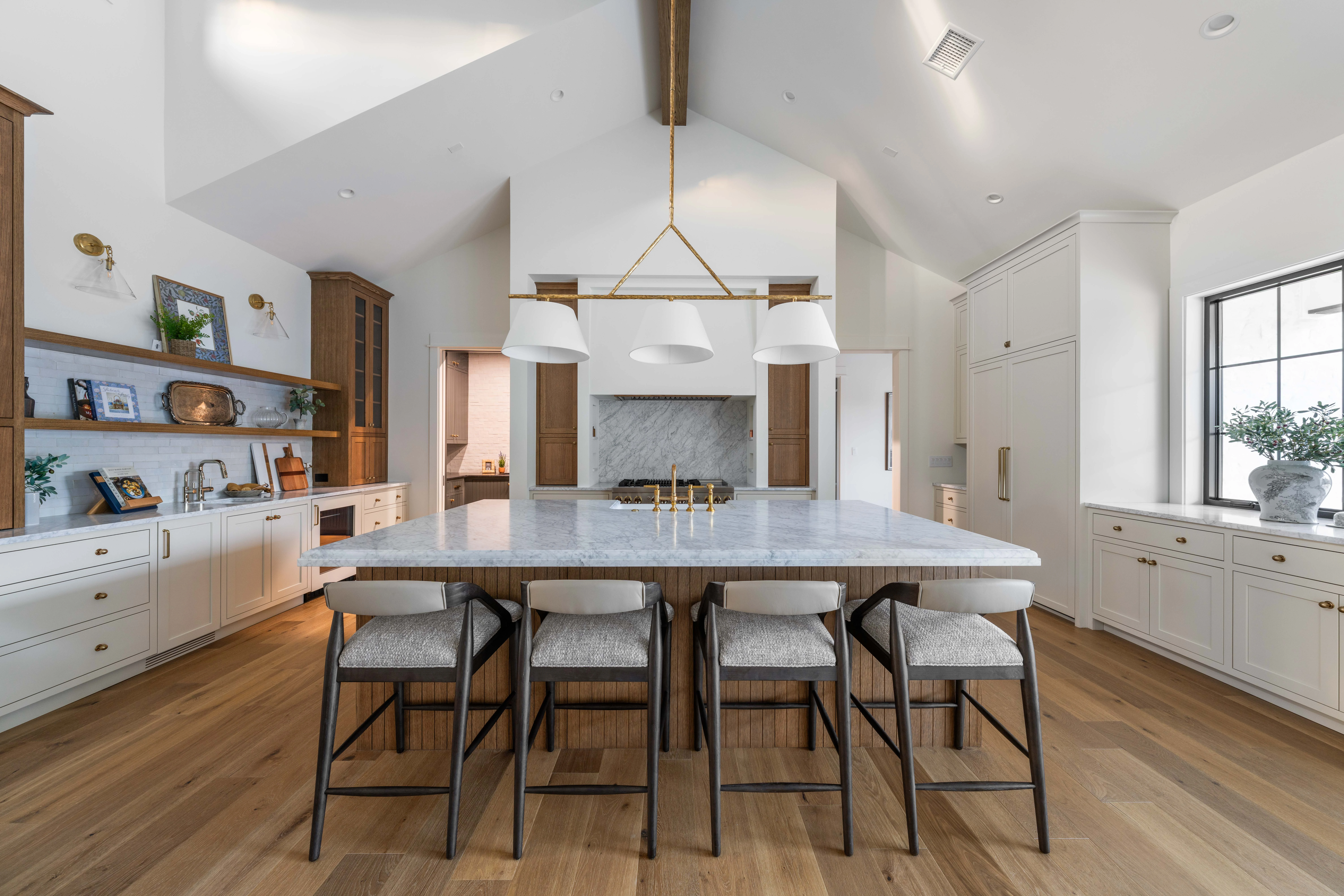 Bianco Carrara island under slim pendants with rattan stools