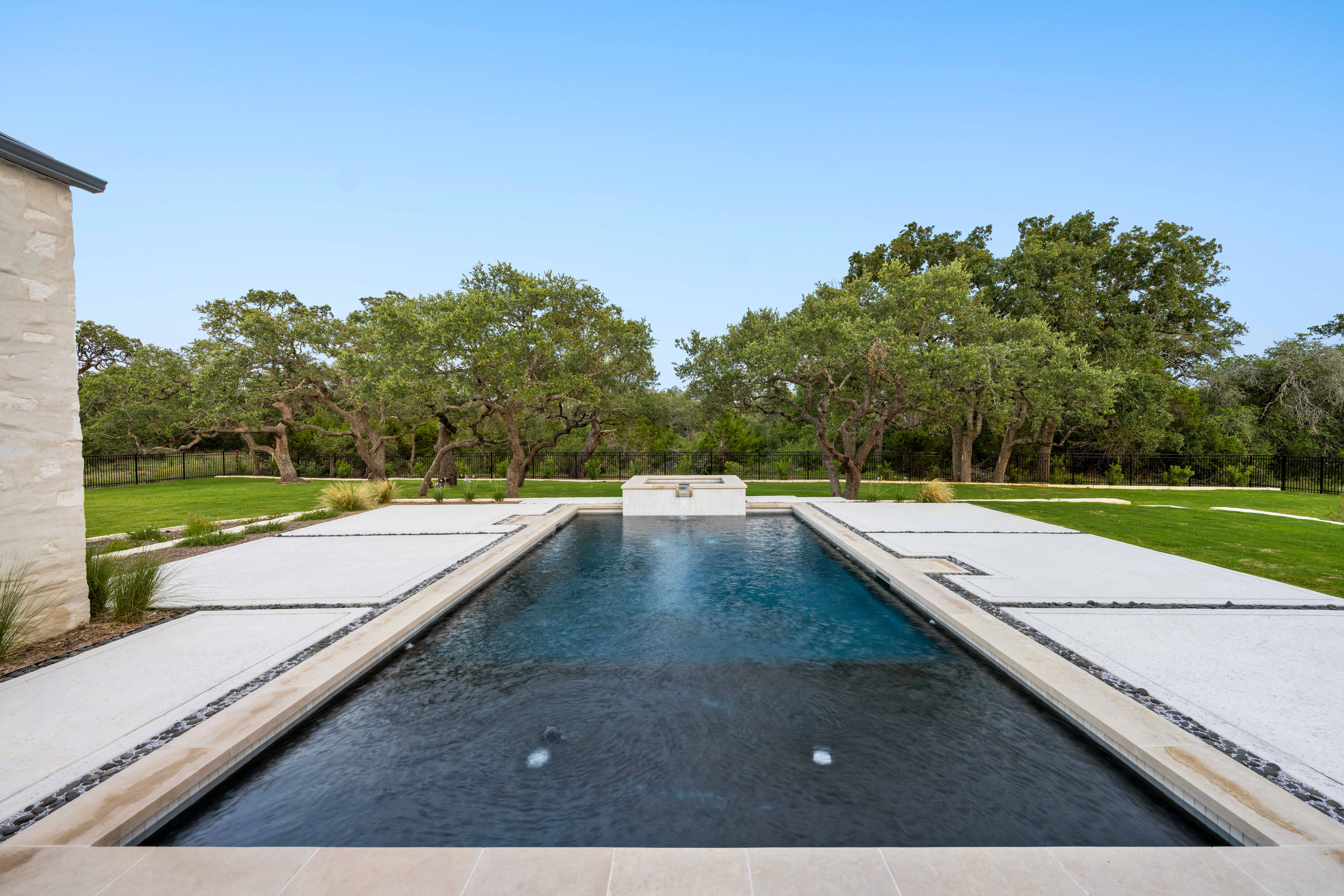 Lap pool running out towards the live oaks