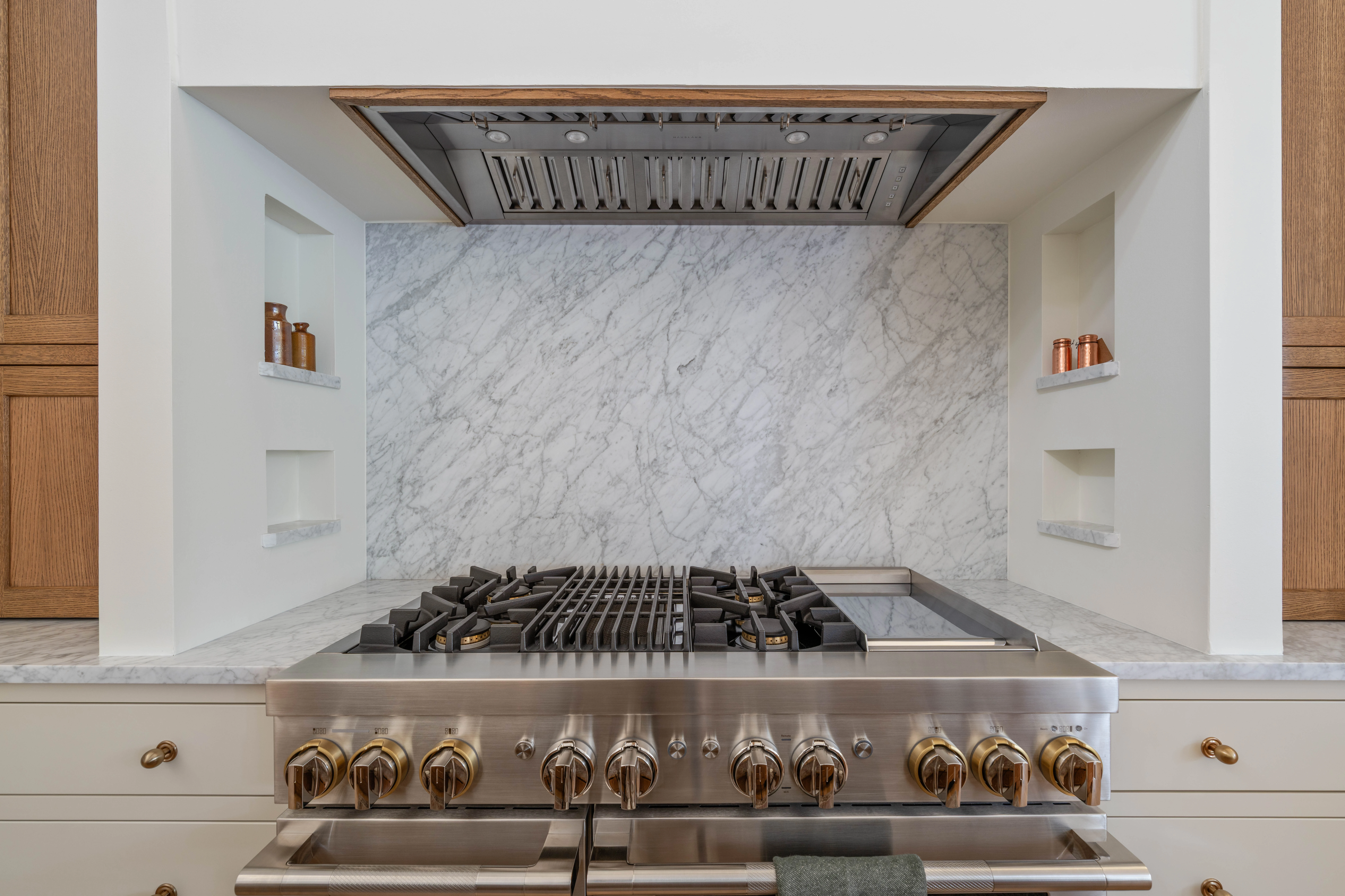 Marble backsplash running behind the range to the ceiling