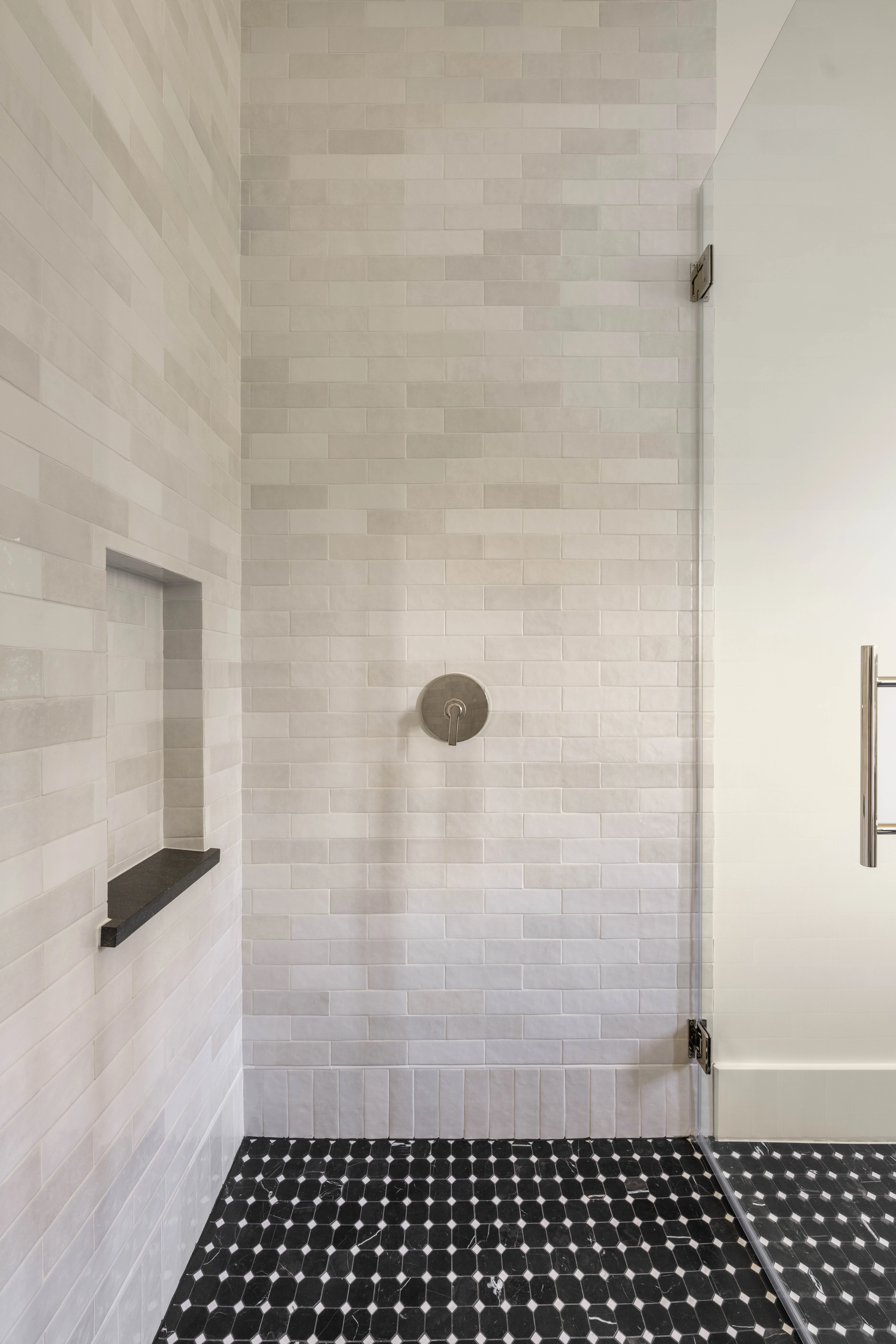 Glass shower enclosure beside the vanity