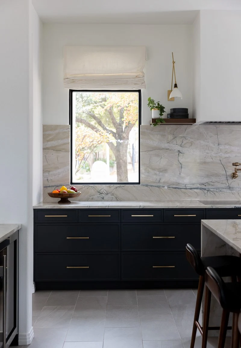Window over the sink framed by the quartzite backsplash