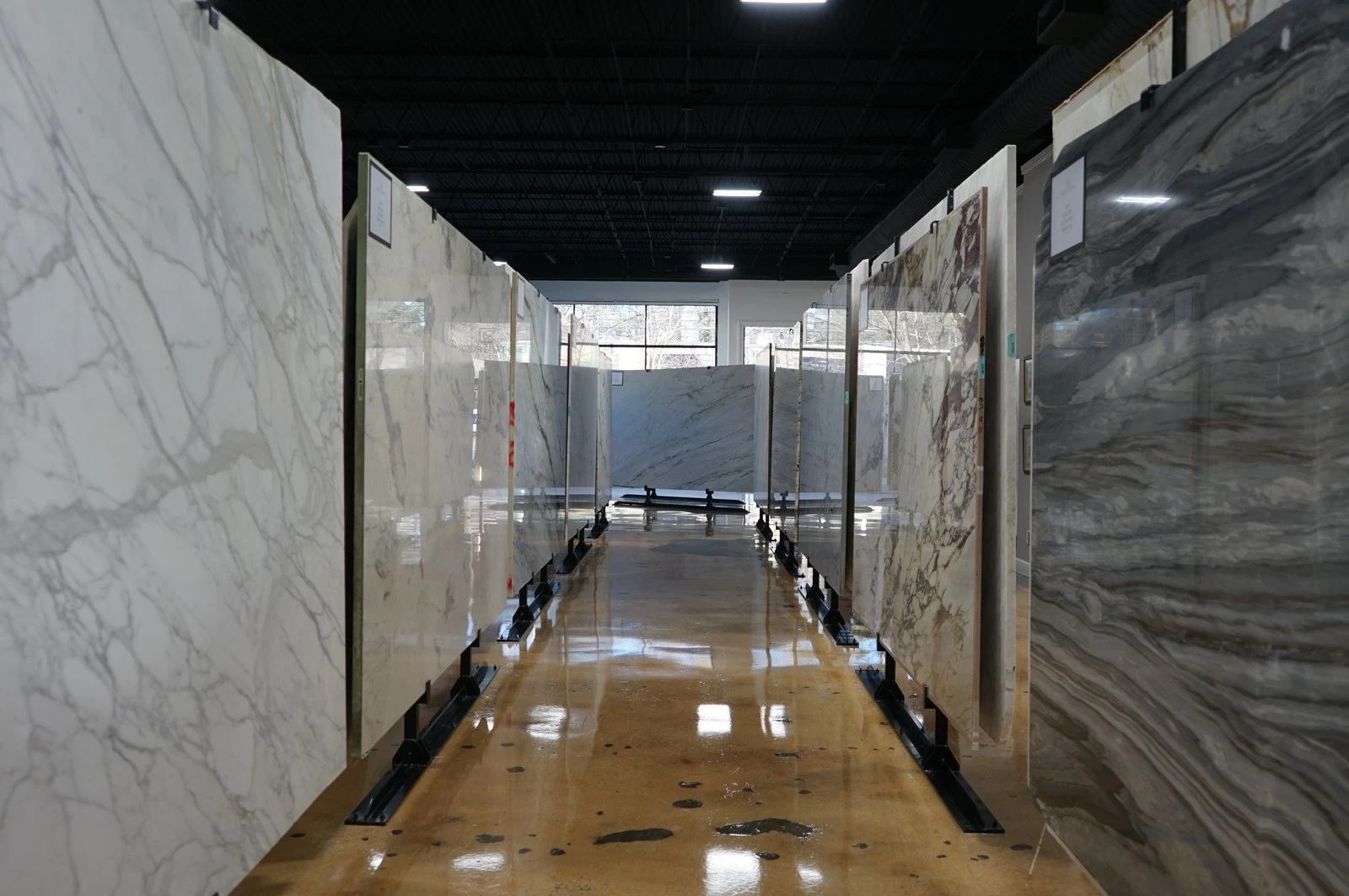 Rows of full stone slabs in the Encore Stone Studio Houston showroom