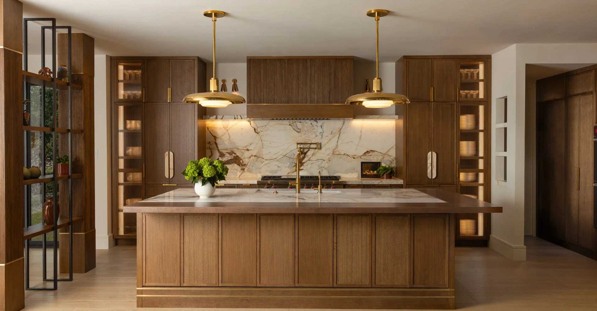 Calacatta Picasso marble range wall and island in a walnut mid-century kitchen