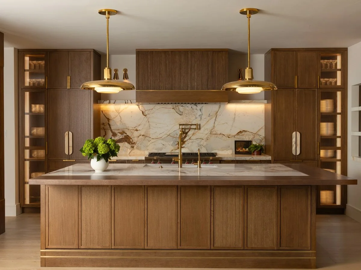 Calacatta Picasso marble range wall and island in a walnut mid-century San Antonio kitchen