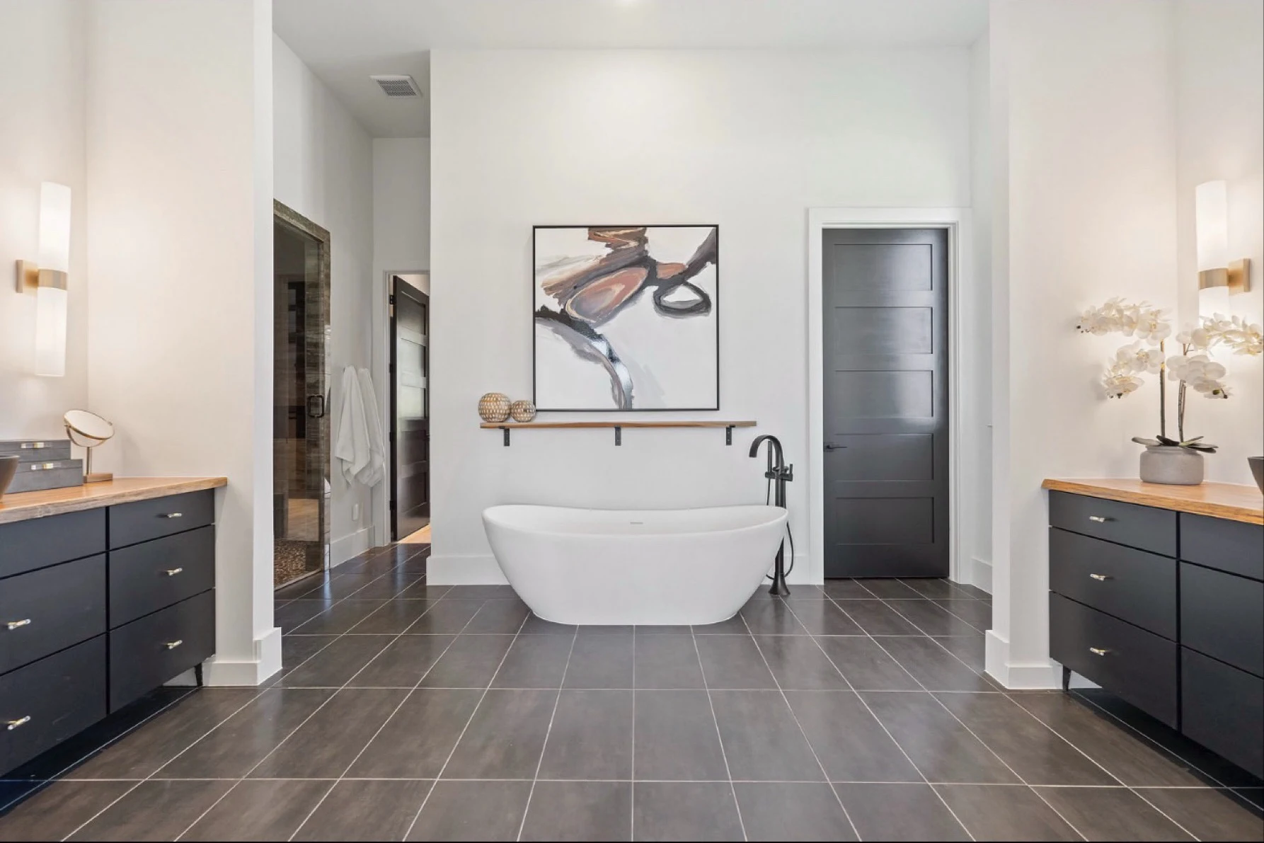 Primary bath before: grey floor tile and plain white walls