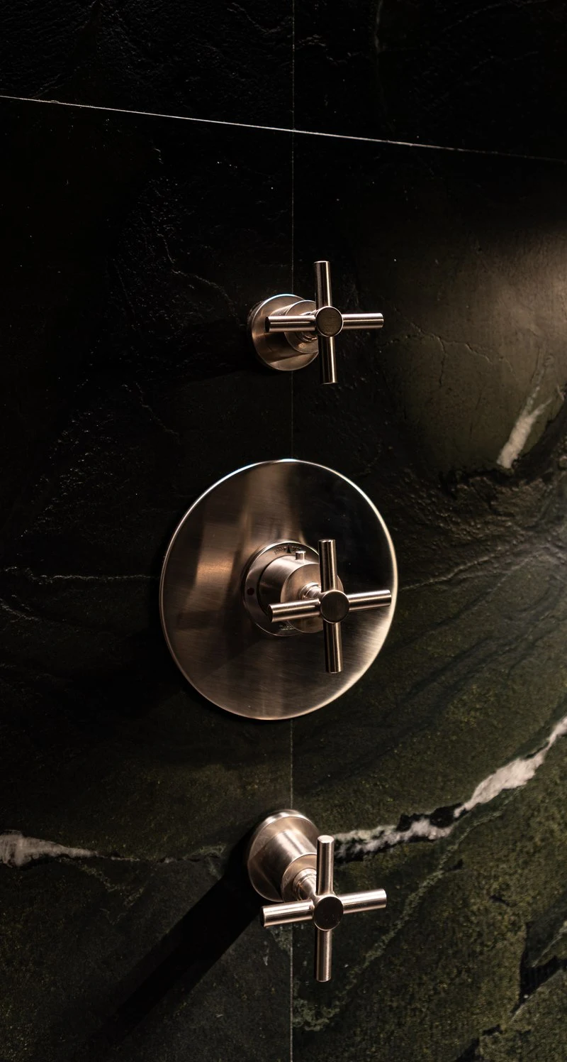 Brass cross handle set into the Avocatus quartzite wall