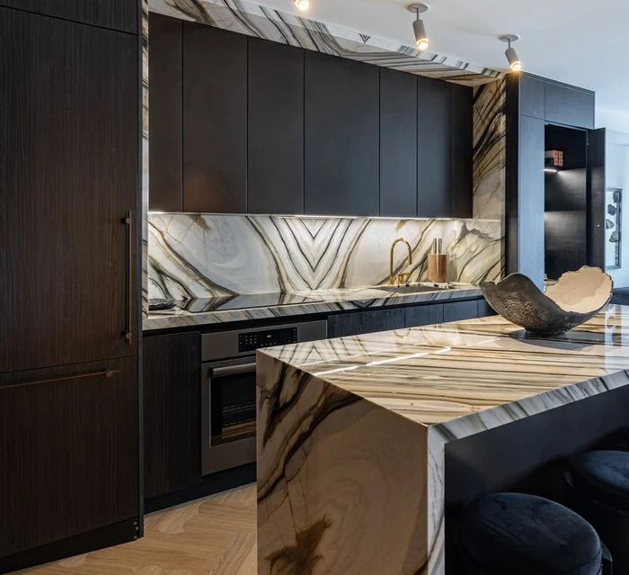 The kitchen island and range wall seen across the room