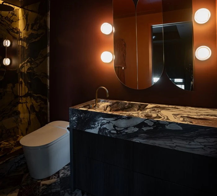 The oxblood powder room seen past the tub