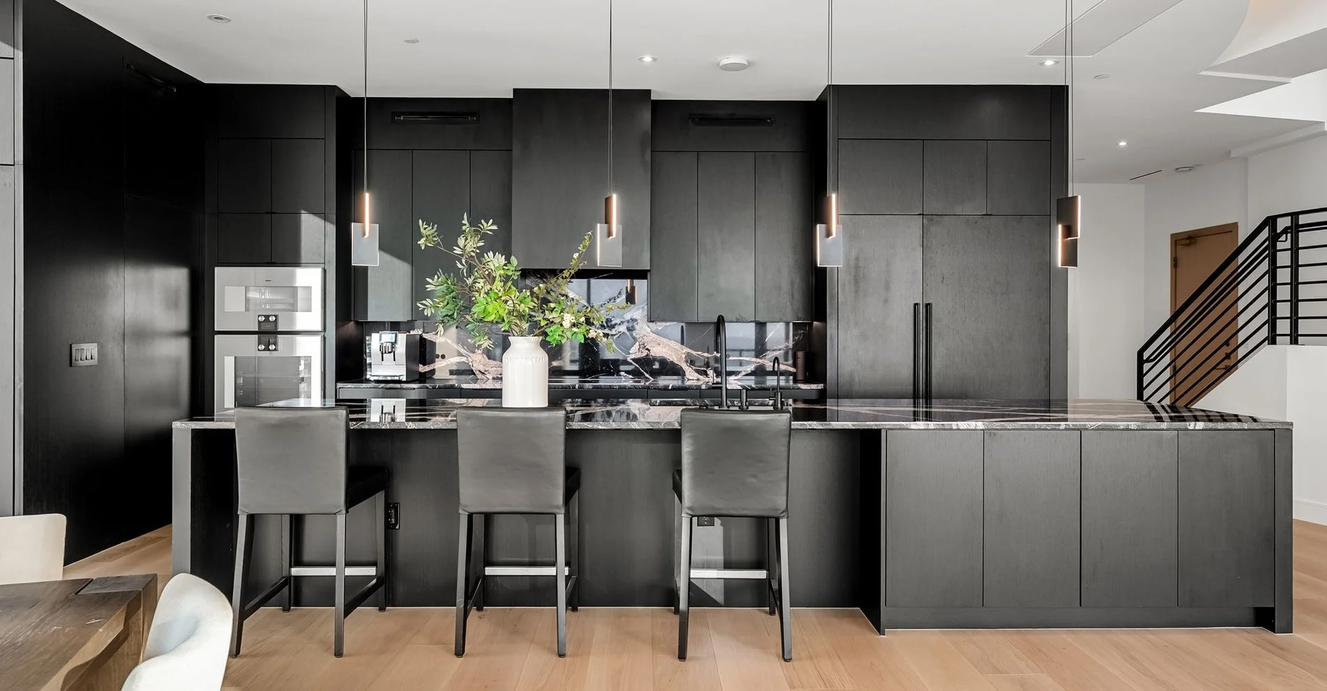Sky Fall granite island and dark matte cabinetry against the Austin skyline