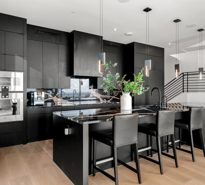 Counter stools at the black island under pendants