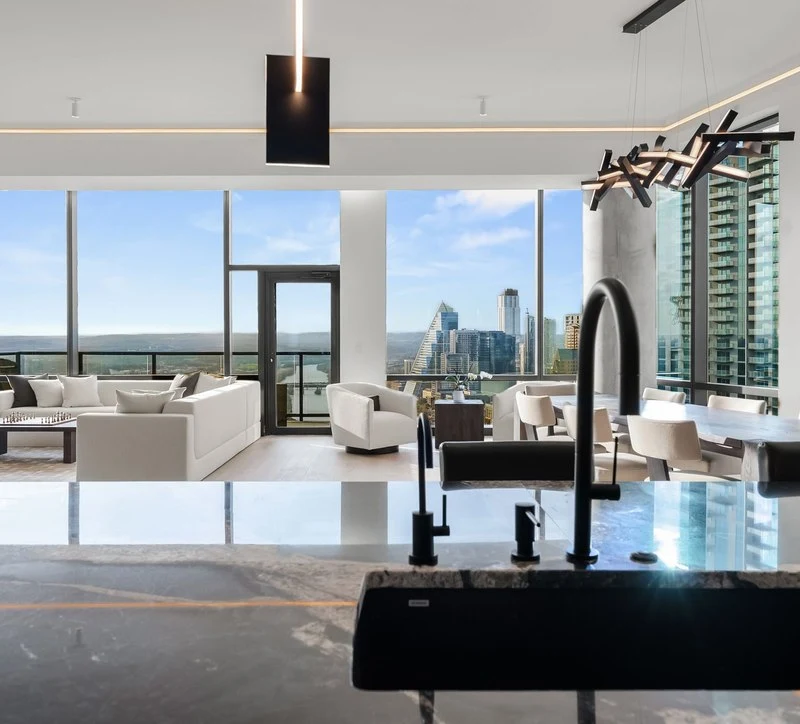 Seating area and skyline windows beyond the kitchen