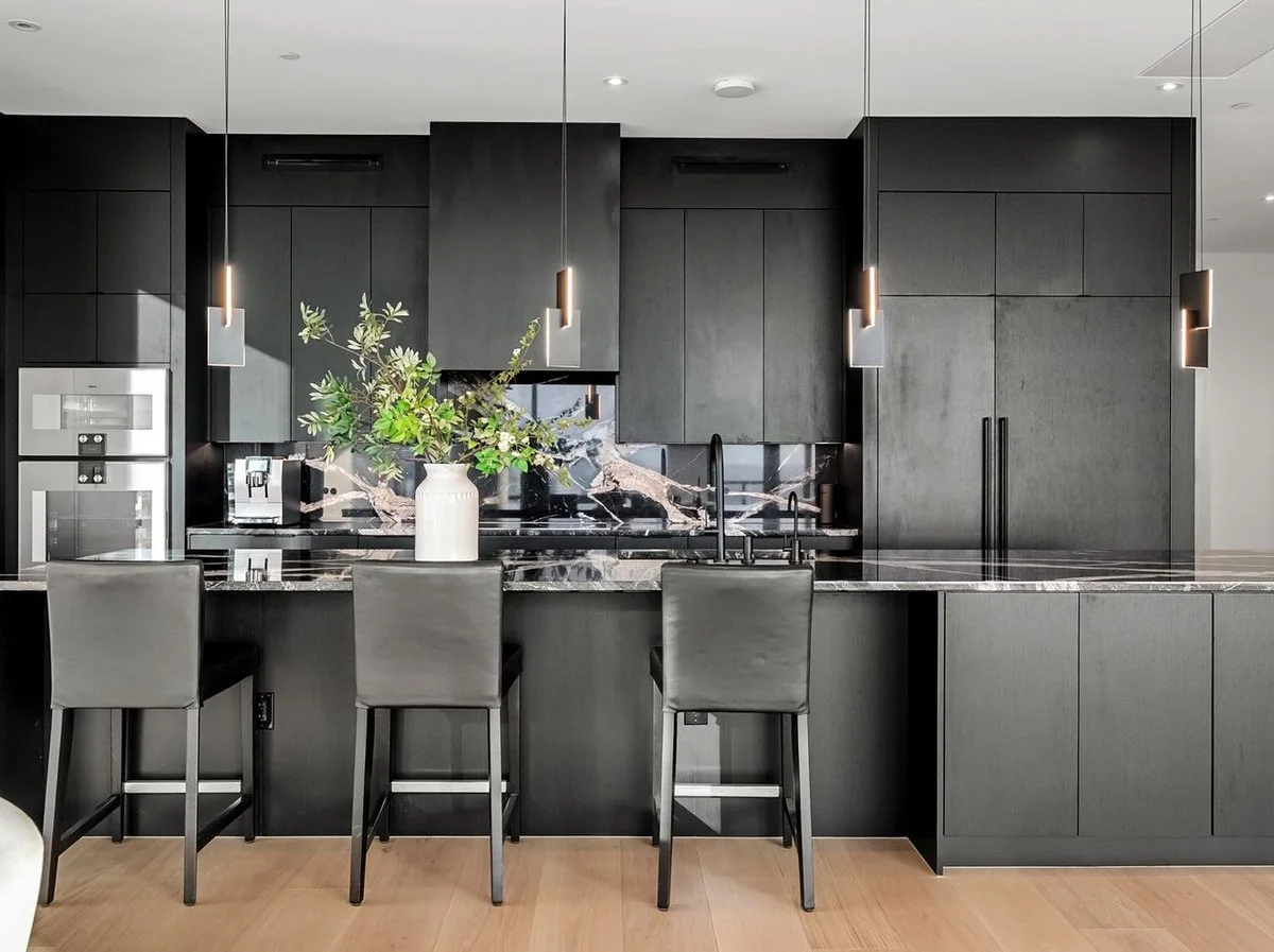 Sky Fall granite island and dark matte cabinetry against the Austin skyline