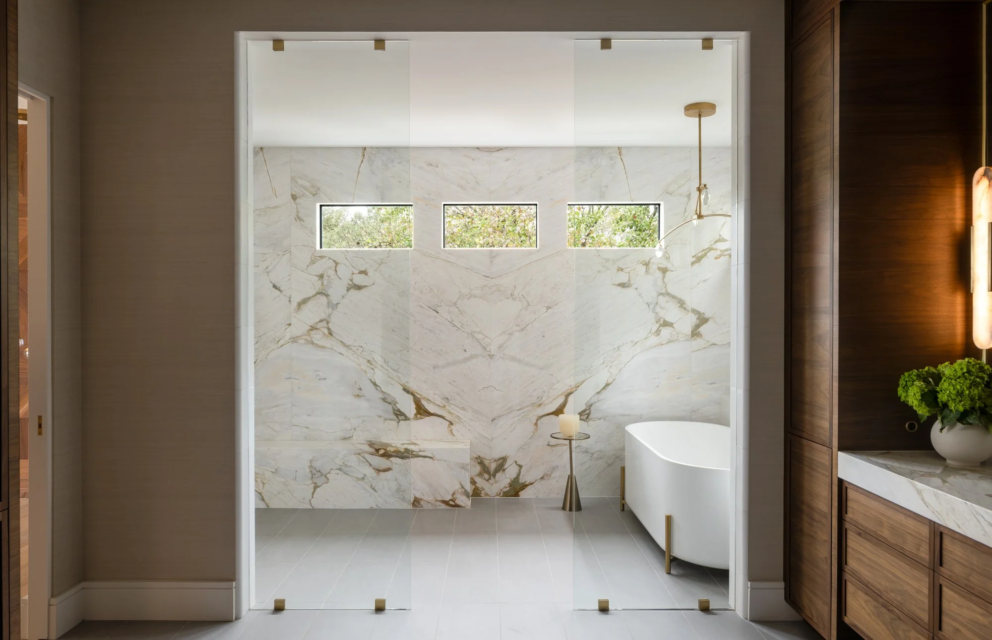 San Antonio bathroom with a marble double vanity and a walk-in shower