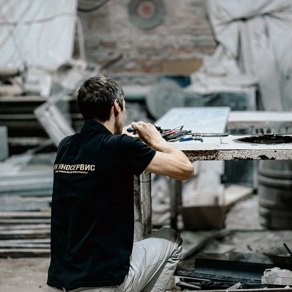 A specialist handling a stone slab before loading