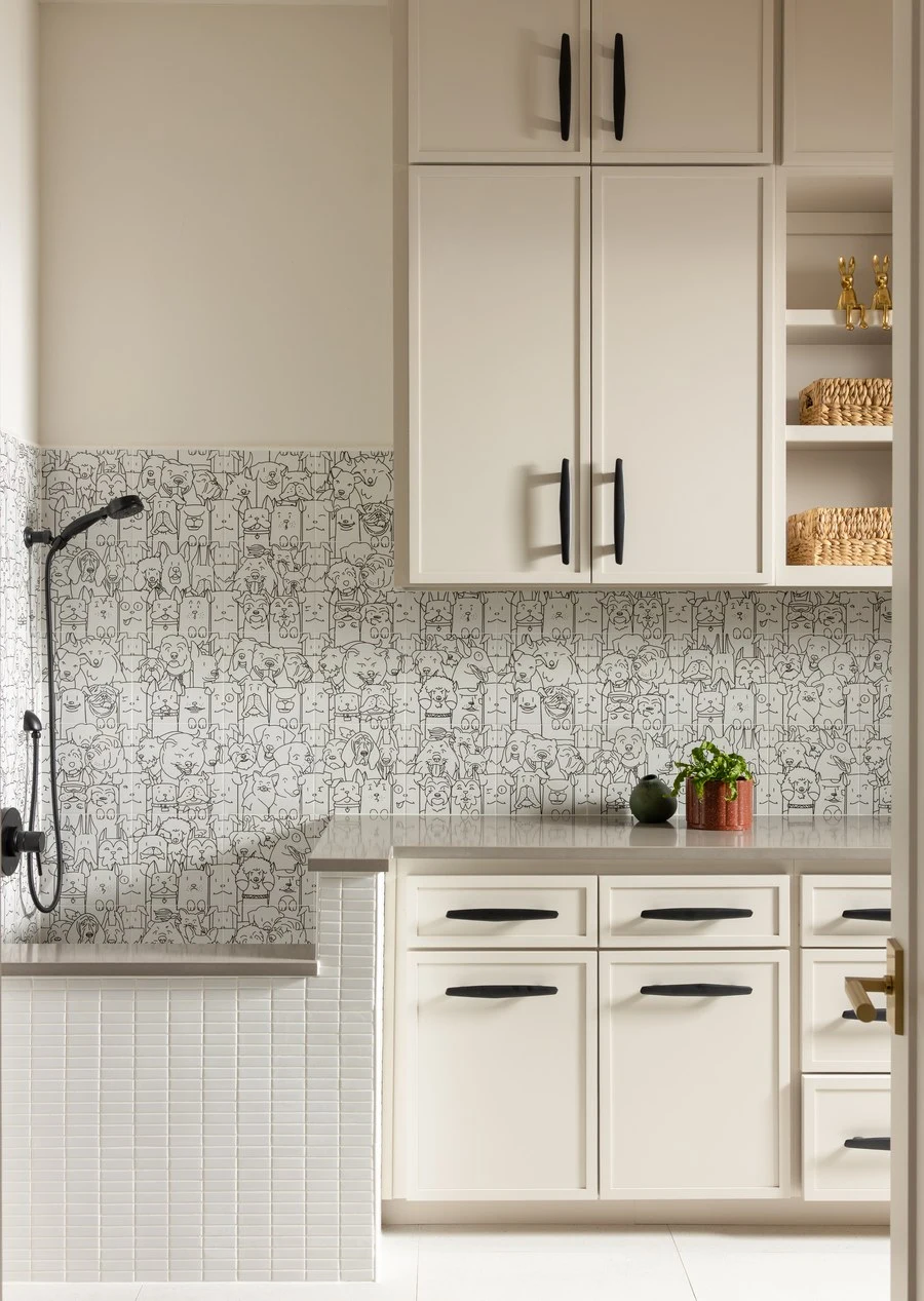 White kitchen with a tile backsplash and potted plants