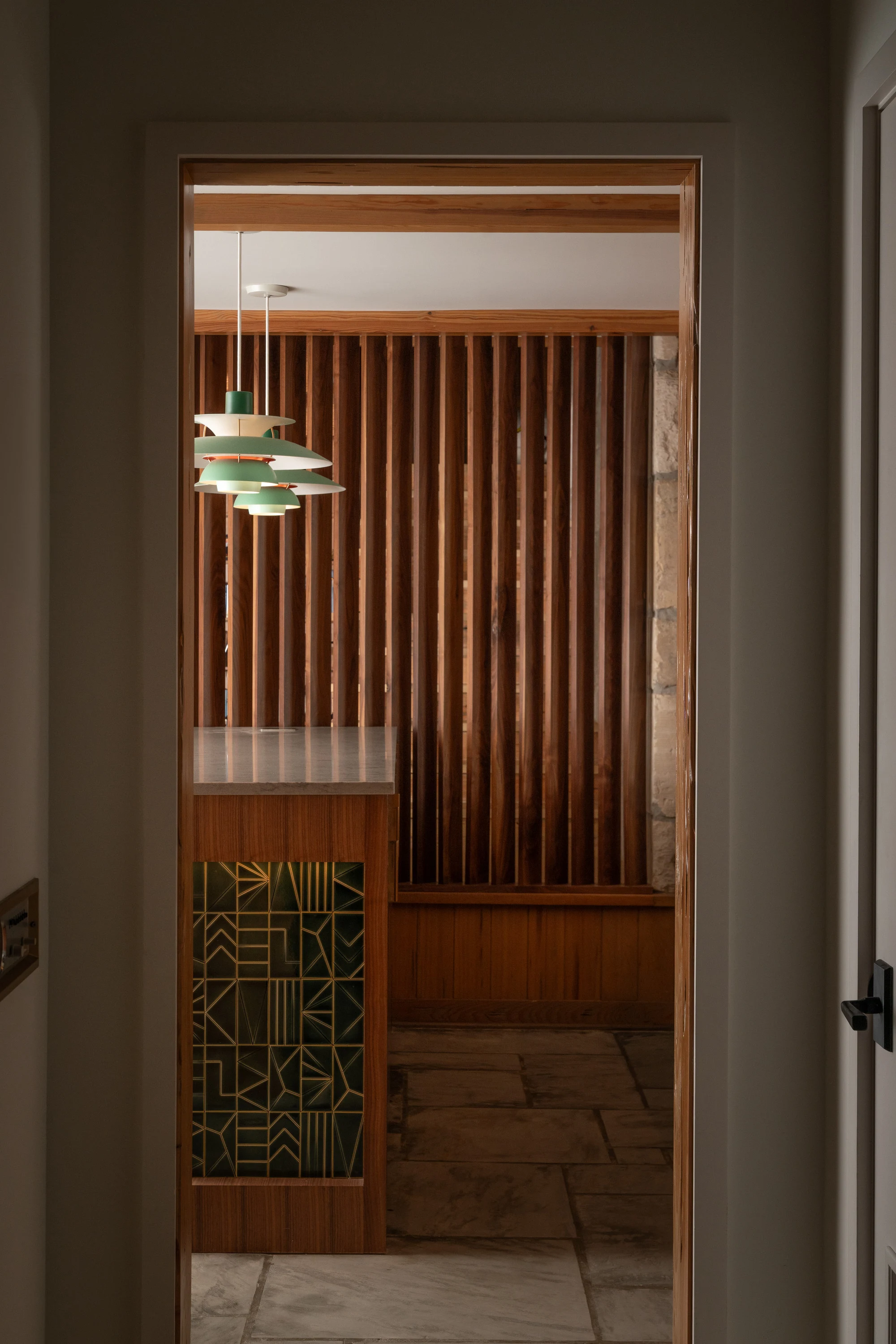 Corridor looking through to the green-tiled bar