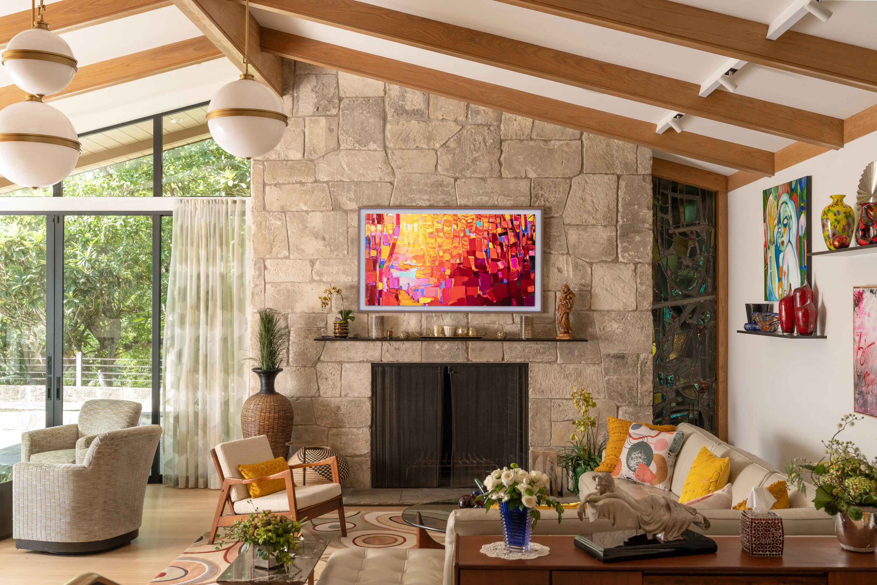 San Antonio living room with a stone fireplace, vaulted timber ceiling and bold artwork