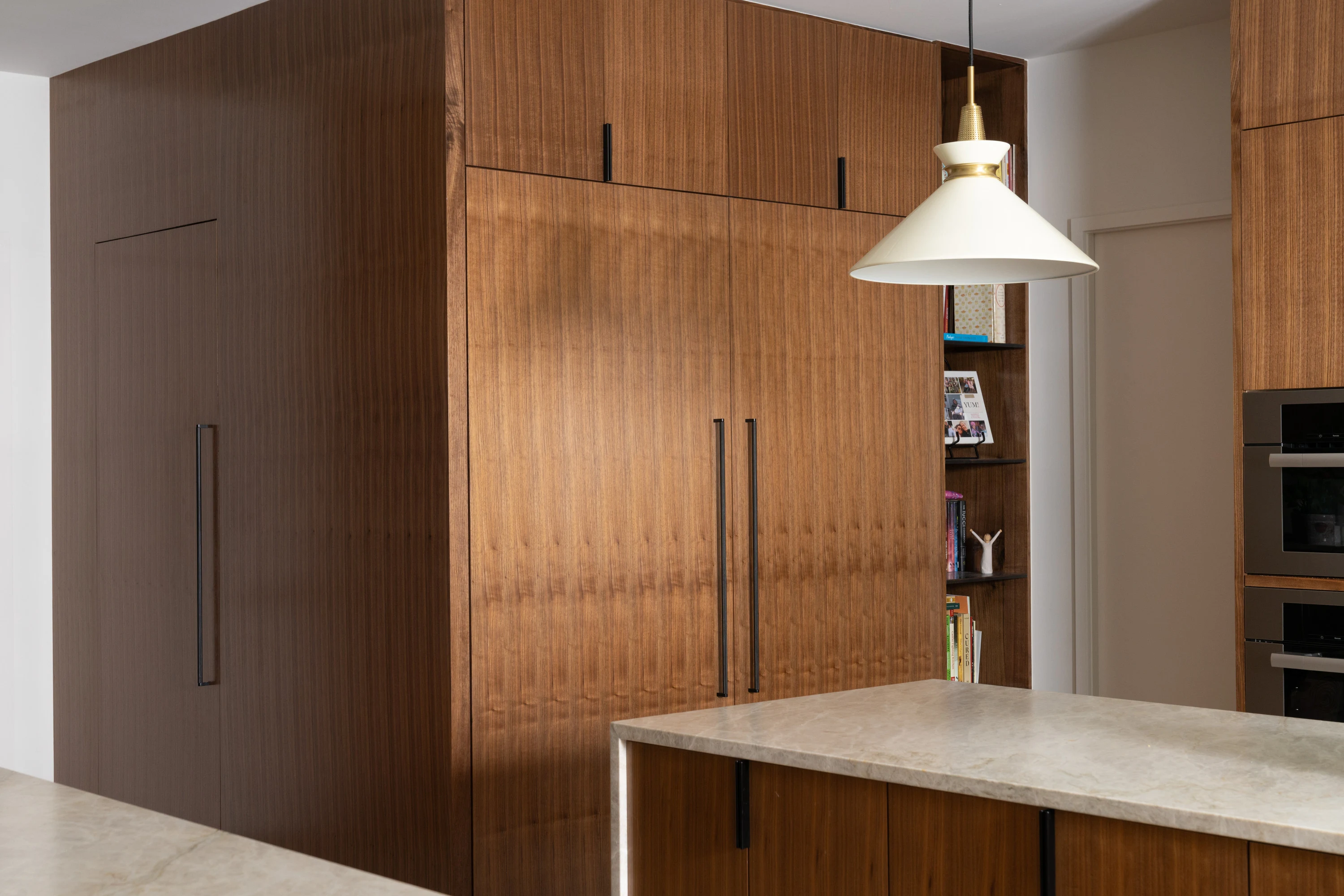 Full-height timber kitchen cabinetry beside the island