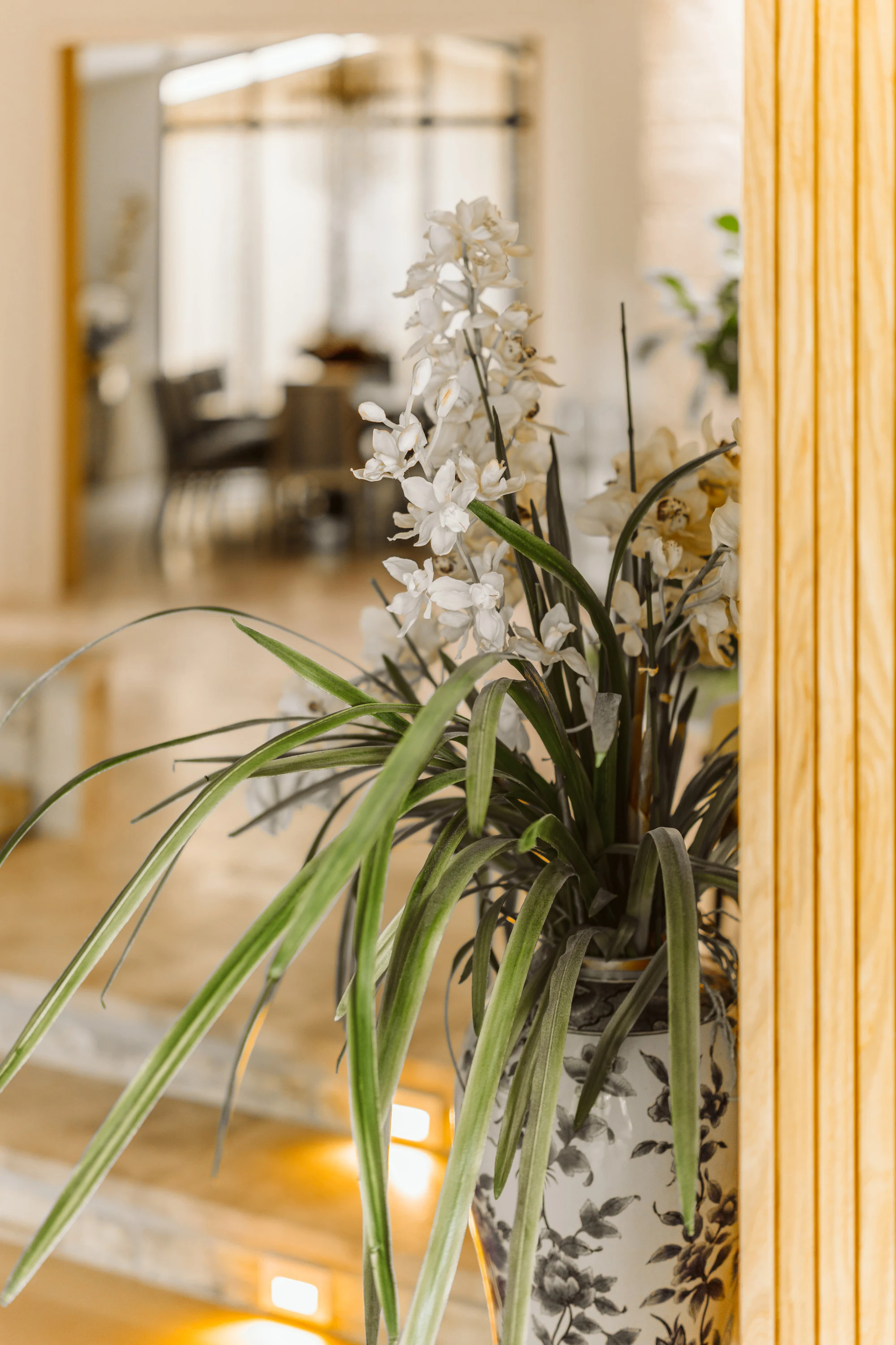Orchid stems against fluted timber panelling